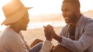 romantic-african-couple-sitting-together-beach-sunset-close-up-trendy-young-holding-hands-sandy-enjoying-104846133